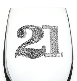 Jewel-encrusted number "21" appears on the bowl of a clear wine glass