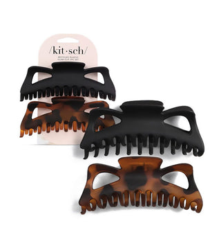 One large matte black and one large matte brown tortoise hair clip on a light pink Kitsch product card and slightly enlarged at right