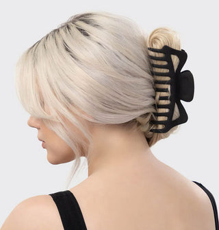 Model wears an extra-large matte black claw clip in a twist hairstyle