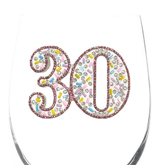 Bowl of a clear wine glass features the number "30" which has been accented by various colors and shapes of rhinestones