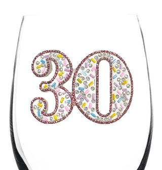 The clear bowl of a wine glass features a "30" decal embellished with rhinestones of varying colors and shapes