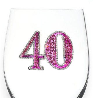 Pink rhinestone-encrusted "40" decal with silver border on the bowl of a clear wine glass