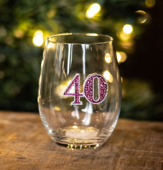 Stemless wine glass features a completely rhinestone-encrusted pink "40" decal on its bowl with a silver border