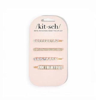 Set of four rhinestone-encrusted bobby pins, each in a different style, on gold-toned hardware attached to a light pink Kitsch product card