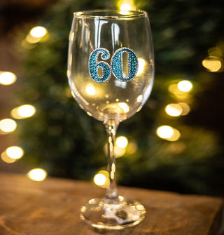 Clear wine glass features a blue rhinestrone-encrusted "60" decal with silver outline