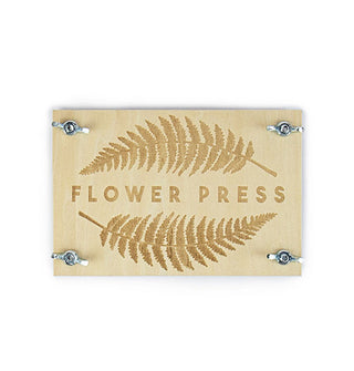 Rectangular wooden flower press with stamped leaf designs and silver wingnuts securing each corner