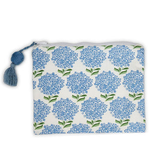 Rectangular white cotton zipper pouch with all-over blue hydrangea print and an attached blue pom-and-tassel zipper pull