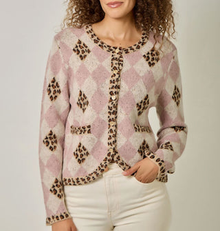 Model wears a pink and white diamond print cardigan with contrasting leopard print diamond accents, neckline, button placket, bottom hem, sleeve cuffs, and pocket edges