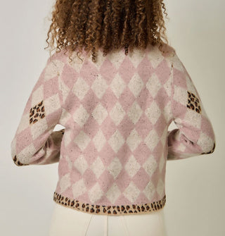 Model wears a pink and white diamond print cardigan with contrasting leopard print diamond accents, bottom hem, and pocket edges
