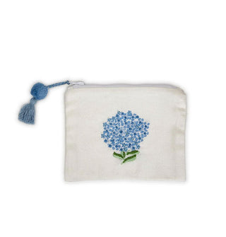 Rectangular white cotton zipper pouch with a blue hydrangea design and an attached blue pom-and-tassel zipper pull