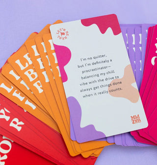 Fanned-out red, orange, and purple MidZen affirmation cards, the top one of which says, "I'm no quitter, but I'm definitely a procrastinator—balancing my chill vibe with the drive to always get things done when it really counts."