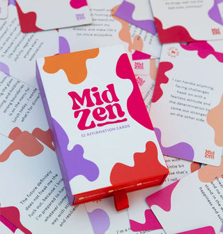 MidZen Affirmation deck box atop a smattering of cards