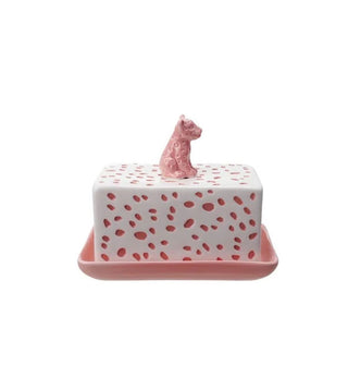 Rectangular pink butter dish with white cover that has pink spots and a pink leopard cub figurine on top to form the handle
