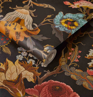 A roll and sample of elegant floral print wallpaper with a black background