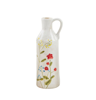 Tall white stem vase with handle features hand-painted design of yellow, blue, and red flowers