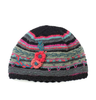 Black, pink, blue, and green striped beanie with a scalloped edge and textural flower and leaf details