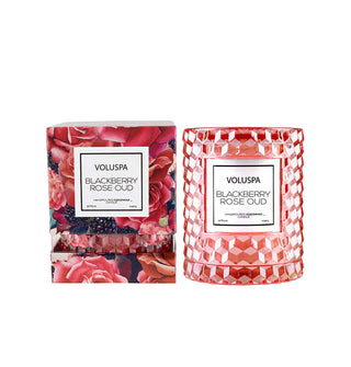 Faceted pinkish-red glass Blackberry Rose Oud Voluspa candle jar with decorative gift box