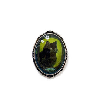 Oval pendant features Art Nouveau-style black cat portrait under convex glass in an antiqued silver frame setting