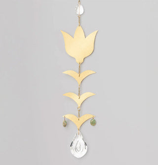 Gold toned brass flower and leaves charms hang from a chain with a small teardrop-shaped crystal at the top, a larger teardrop-shaped crystal at the bottom, and two green aqua terra stones on either side of the bottom leaves