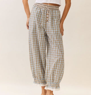 Model wears plaid bloomer-style pants with elasticated, lace-trimmed ankle cuffs