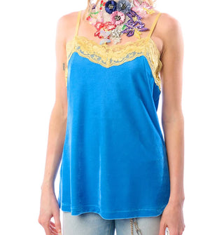 Model wears a blue velvet camisole with yellow lace trim and straps paired with an ornate embroidered floral choker necklace