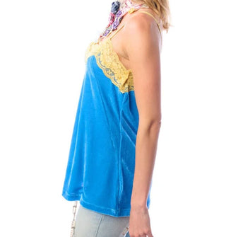 Model in profile view wears a blue velvet camisole with yellow lace trim and straps