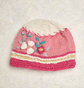 Knit beanie with pink, white, and yellow striped border, pink middle with floral embroidery, and a white tip separated from the pink middle by pink vine-like stitching