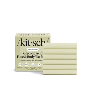 Ribbed square green bar of Kitsch Resurfacing Glycolic Acid Face & Body Wash Bar sits alongside and slightly in front of its box packaging