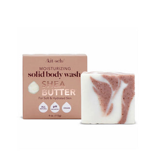 Swirled, flecked pink and white bar of Kitsch Moisturizing Shea Butter Solid Body Wash sits next to its box packaging