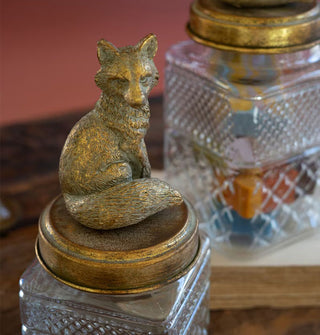 Closeup of a brass fox figurine glass canister lid