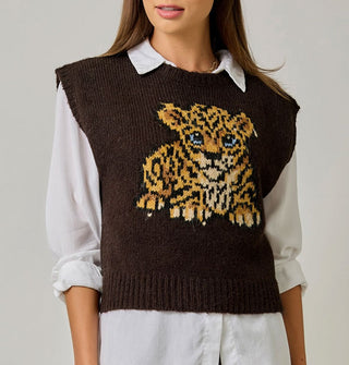 Model wears a brown sweater vest with blue-eyed leopard cub graphic over a white collared button-down shirt