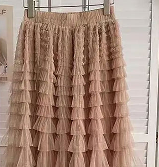Tan tiered ruffle tulle skirt on a hanger in front of white closet doors