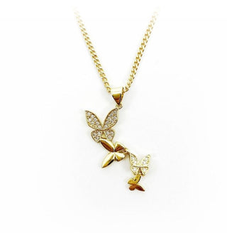Gold four-butterfly pendant with gemstone accents is strung on a gold chain