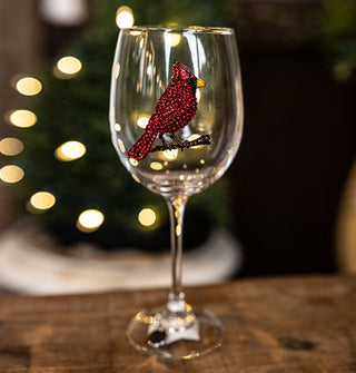 Clear wine glass is accented with a red jewel-encrusted cardinal bird decal