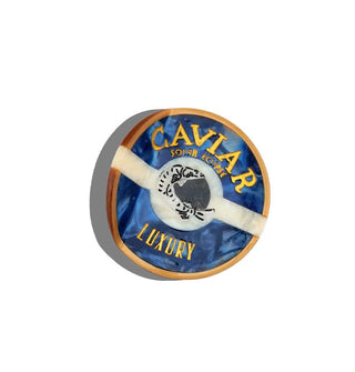 Round hair clip designed to resemble a tin of caviar
