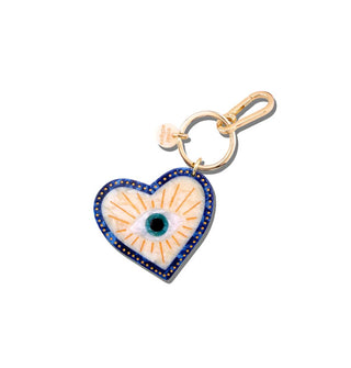 Heart-shaped acetate charm with blue border and central radiant eye design hangs from a gold keyring with tab and lobster clasp attached