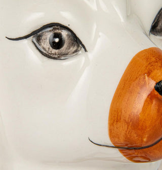 Closeup of the painted detail of a ceramic Staffordshire dog's face