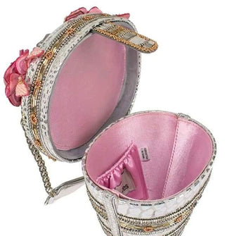 Handbag interior features pink satin lining and an elasticated pocket