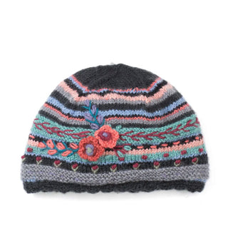 Dark gray, blue, pink, and green striped beanie with a scalloped edge and textural flower and leaf details