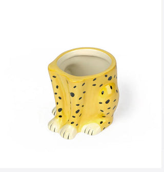 Ceramic planter shaped and painted to resemble the bottom half of a sitting cheetah