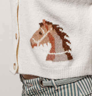 Closeup of the brown horse design on a white sweater