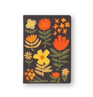 Dark gray journal cover features bold, colorful embroidered flower designs