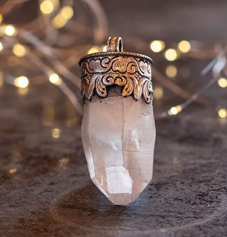 Chunk of clear crystal quartz in a decorative silver necklace pendant setting