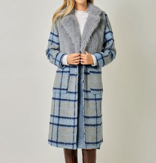 Model wears a blue and gray plaid brushed fiber coat with solid gray faux fur bodice