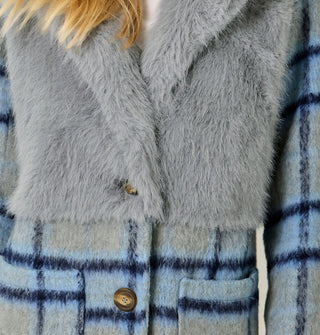Model wears a blue and gray plaid brushed fiber coat with solid gray faux fur bodice