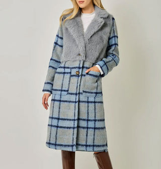Model wears a blue and gray plaid brushed fiber coat with solid gray faux fur bodice