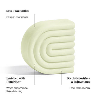 Light green C-shaped ribbed conditioner bar is labeled with its key benefits: Save Two Bottles, Enriched with Dandrilys®, and Deeply Nourishes & Rejuvenates