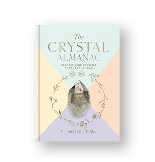 Pastel color-blocked cover of The Crystal Almanac by Gemma Petherbridge features a central graphic of a gemstone surrounded by a delicate illustrated floral border