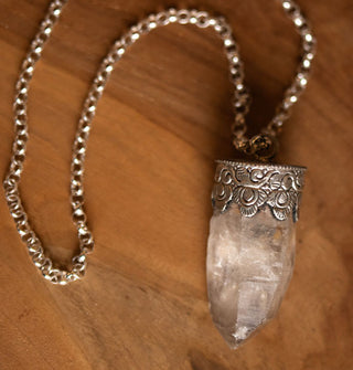 Clear crystal quartz point pendant in ornate silver setting on thick silver belcher chain