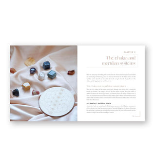 Page spread from Crystal Rituals by the Moon features a chapter introduction titled, "The Chakra and Meridian Systems" alongside a photograph of several polished gemstones with a Flower of Life sacred geometry disc